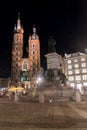 Main Market Square with Adam Mickiewicz monument and Saint Mary`s Basilica in Old Town of Krakow at night Royalty Free Stock Photo