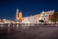 Main Market Square at night with St. Mary`s Basilica and Church of St. Wojciech - Krakow, Poland Royalty Free Stock Photo