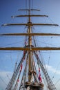 Main mast of tall ship with rolled up sail