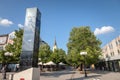 Main pedestrian street of Indjija, Ulica Vojvode Stepe, with a church, a clock tower, trees and cafes visible. Royalty Free Stock Photo