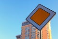 Main road sign against blurred residential building and blue sky. Traffic sign the main road. Concept of road sign Royalty Free Stock Photo