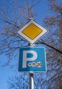 The main road sign and the parking sign on the same pole . Royalty Free Stock Photo