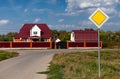 main road sign standing at the intersection of roads in a small settlement Royalty Free Stock Photo