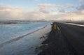 Main road in winter time with blue water on the edges, Iceland