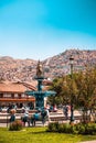 Main Square with a fountain and cityscape of Cusco, Peru, vertical