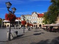 Main square in historical city center of Bielsko-Biala in POLAND with colorful old buildings, street lamps, red flowers.