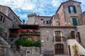 The main square of little medieval town of Capalbio, Tuscany, Italy, with buildings and flowers