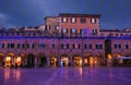 The main square Piazza del Popolo of Ascoli Piceno with christmas lights and decorations at dusk on winter holiday day