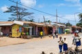 Main street of Chake Chake town, capital of Pemba Island, with poor smalll tin houses, shops and school children walking.