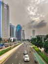 main street in jakarta city, Indonesia with buildings and cloudy sky