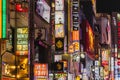 main street of Kabukicho with illuminated neon lights at night in Tokyo, Japan