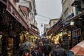Main street of Kadikoy market, on the Asian side of the city, with restaurants around, crowded, during a snow storm in winter Royalty Free Stock Photo