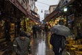 Main street of Kadikoy market, on the Asian side of the city, with restaurants around, crowded, during a snow storm in winter Royalty Free Stock Photo