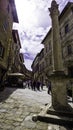 Main street of Montalcino with historical column and bar for tourists