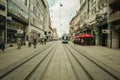 Main street of Osijek, Ulica Strossmayera Street, with pedestrian & tramway rails & a tram passing by.