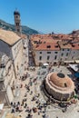 Main street Stradun full of tourists near church of St. Saviour and Big Onofrio`s fountain Royalty Free Stock Photo