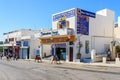 Main street of Thira town with office of Travel agency Royalty Free Stock Photo