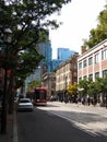 Main street of Toronto in Canada, with a tram, people walking, a church and the skyscrapers of the business district