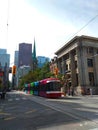 Main street of Toronto in Canada, with a tram, people walking, a church and the skyscrapers of the business district