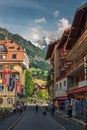 Main street of Wengen village with view over mountains in Switzerland