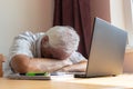 Senior old man male sit desk, home office online notebook laptop work distance freelancer tired unhappy sad sleeping Royalty Free Stock Photo