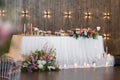 Main table at a wedding reception with beautiful flowers. Wedding decoations with pink flowers.