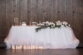 Main table at a wedding reception with beautiful fresh flowers. Wedding day.