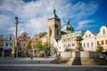 Main town square with Havlickuv Brod`s Cathedral, Plague column and fountain, Church of Assumption of the Virgin Mary in summer