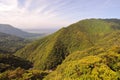 Main view of the northern massive green mountains and seaside of Yakushima Island with city of Miyanoura on background Royalty Free Stock Photo