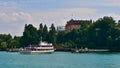 Passenger ferry ship arriving at landing stage of flower island Mainau, Lake Constance.