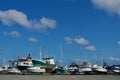 Maine boat yard under clouds in blue sky, early fall, with many boats