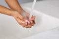 Maintaining cleanliness and hygiene. hands being washed at a tap.