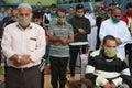 Maintaining the social distancing, gather to perform Eid al-Fitr prayer in a sports court within precautions against the novel cor