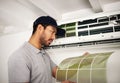 Maintenance, air conditioner and man checking filter, technician working on ventilation and ac repair. Contractor Royalty Free Stock Photo