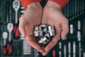 Maintenance automotive garage concept of human mechanic hands wearing red clothes holding chrome sockets on background of tool box Royalty Free Stock Photo