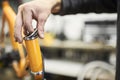 Maintenance of a bicycle: person disassembling an orange bike in his workshop