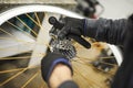 Maintenance of a bicycle: person disassembling sprocket set of a bike wheel