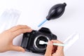 Photographer hand cleaning sensor of camera by using sensor swab