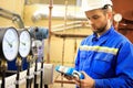 Maintenance engineer controls a work technological process and tests a work gauge pressure