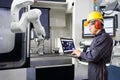 Maintenance engineer using laptop computer control automatic robotic hand with CNC machine in smart factory, Industry 4.0 concept Royalty Free Stock Photo