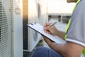 maintenance engineer works on the roof of factory. contractor inspect compressor system and plans installation of air condition