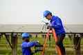 Maintenance engineers installing solar panels on solar cell farm Royalty Free Stock Photo