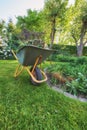 Maintenance equipment on cut fresh green grass in a clean backyard used for gardening, moving plants, vegetations, dry Royalty Free Stock Photo