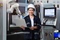 Maintenance female engineer using laptop computer control automatic robotic hand with CNC machine in smart factory, Industry 4.0 Royalty Free Stock Photo