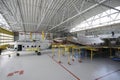 Maintenance hall with planes standing in aircraft fixtures for repair. The State Aircraft Repair Plant 410