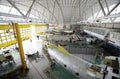 Maintenance hall with planes standing in aircraft fixtures for repair. The State Aircraft Repair Plant 410