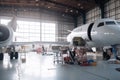 maintenance hangar, with team of technicians performing routine checkups on aircraft Royalty Free Stock Photo