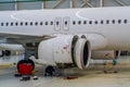 Maintenance Mechanic is Inspecting and Working on Airplane Jet Engine in Hangar Royalty Free Stock Photo