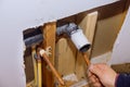 Maintenance plumber service home bathroom in repair of plastic polypropylene water pipes in hole wall