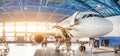 Maintenance and repair of aircraft in the aviation hangar of the airport, view of a wide panorama Royalty Free Stock Photo
